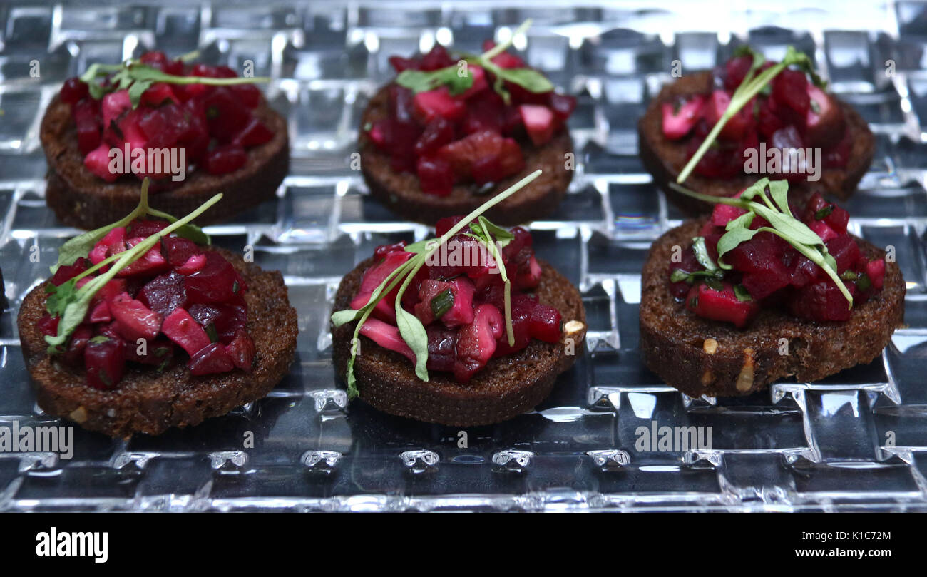 Roasted beet hors d'oeuvres on dark bread with parsley topping Stock Photo