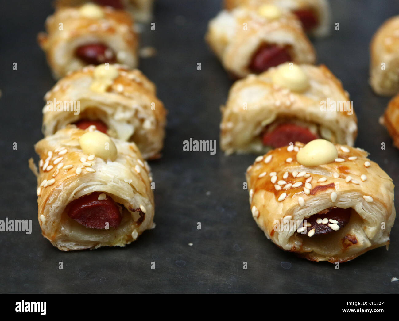 Pigs in a blanket hors d'oeuvres with mustard droplet Stock Photo