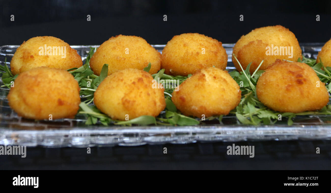 Fried cheese balls filled with mozzarella cheese hors d'oeuvres on crystal dish Stock Photo