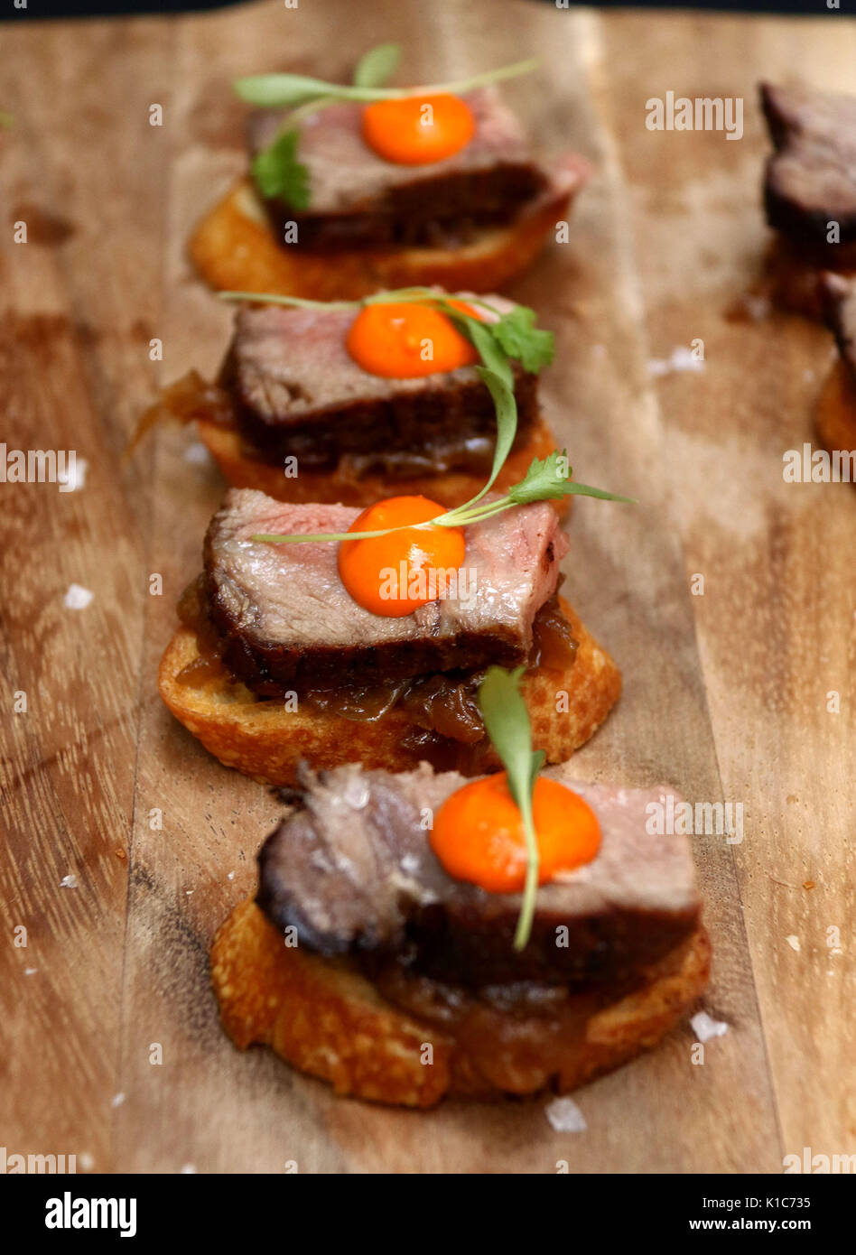 Wooden carving board with beef tenderloin with egg yolk hors d'oeuvres