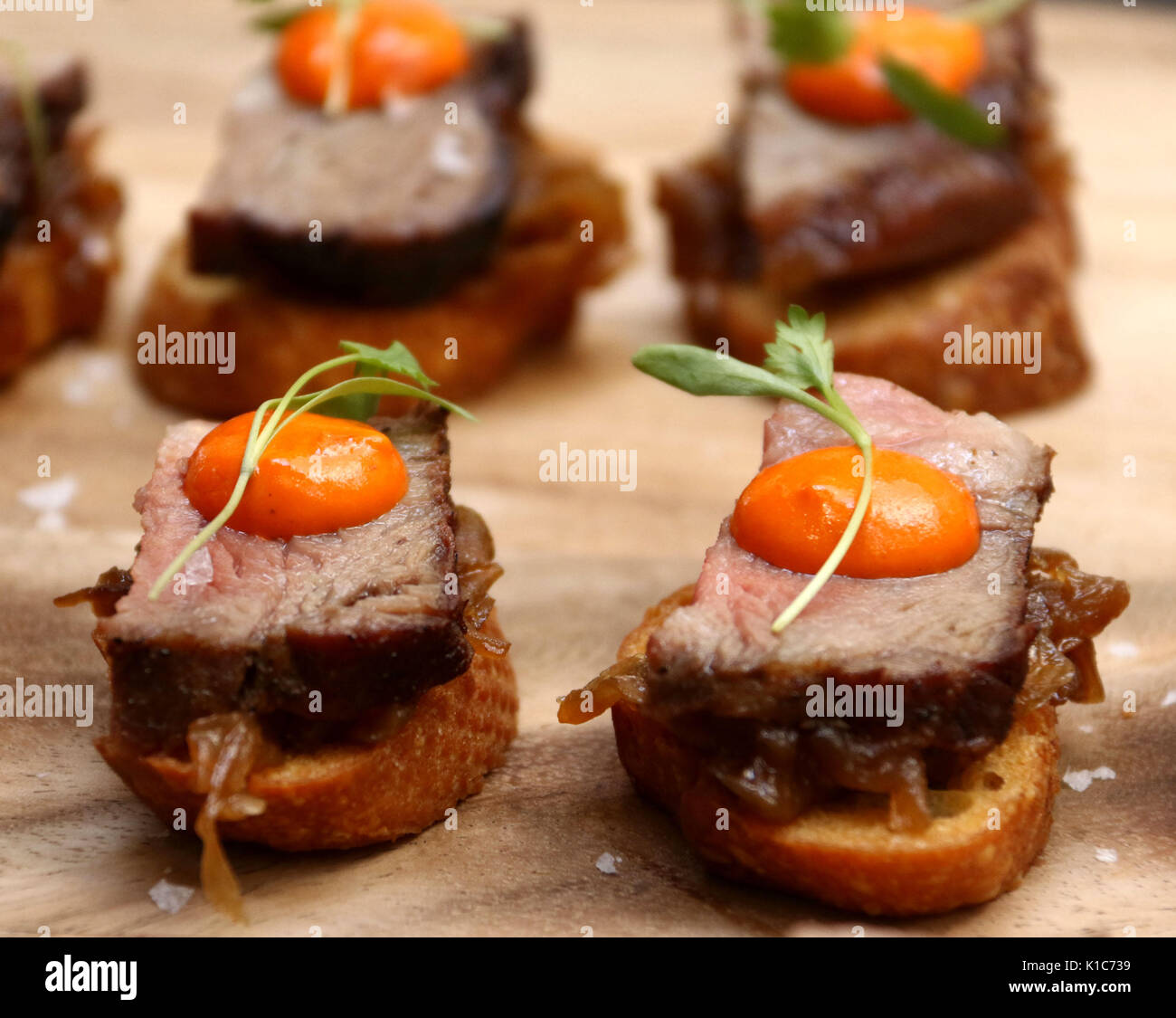 Wooden carving board with beef tenderloin with egg yolk hors d'oeuvres