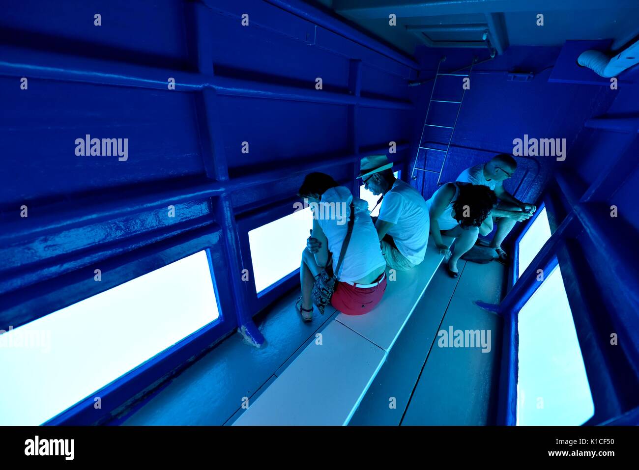 Tourists in a Glass bottomed boat viewing area Stock Photo