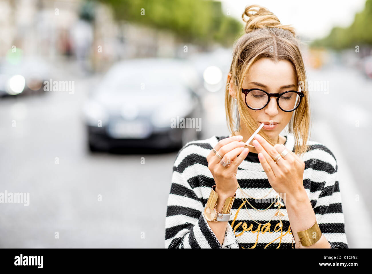 Woman smoking on the street Stock Photo