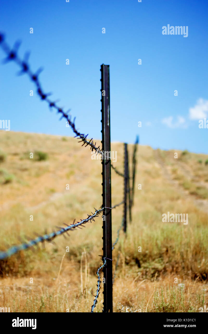 A metal barbed wire fence post on a Utah desert hillside Stock Photo - Alamy