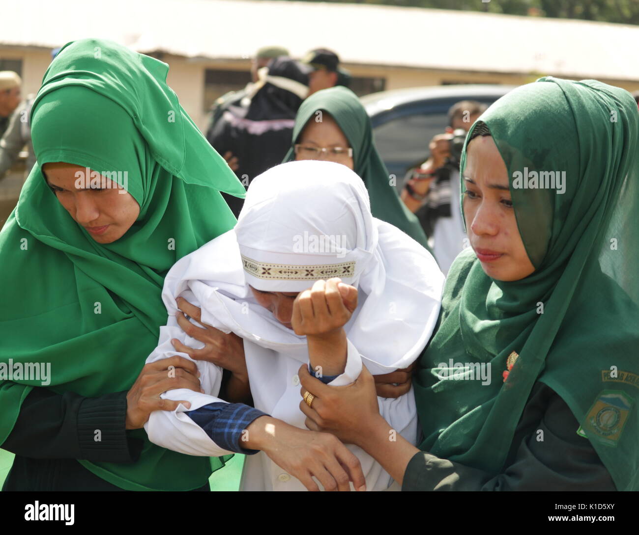 Aceh Besar, Indonesia. 25th Aug, 2017. An offender of sharia law in pain after being flogged in Jantho, Aceh Besar Regency, Aceh Province, Indonesia. After serving the caning, every offender will be checked for health. Credit: Abdul Hadi Firsawan/Pacific Press/Alamy Live News Stock Photo