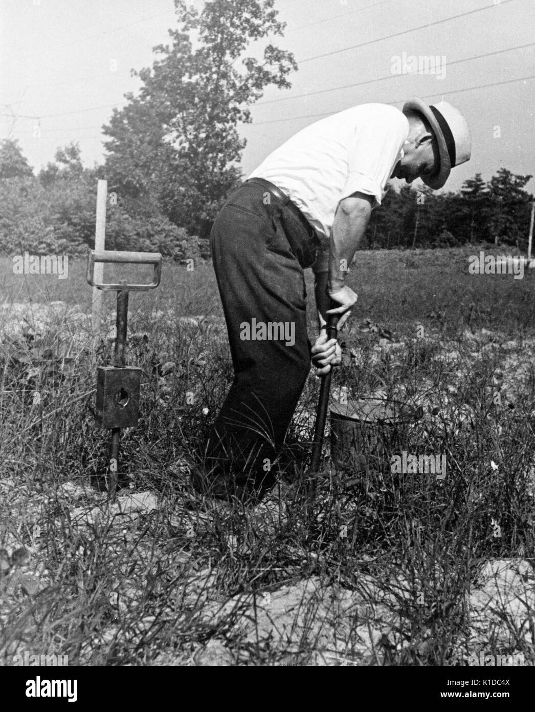 Worker performing a moisture test on soil at the United States