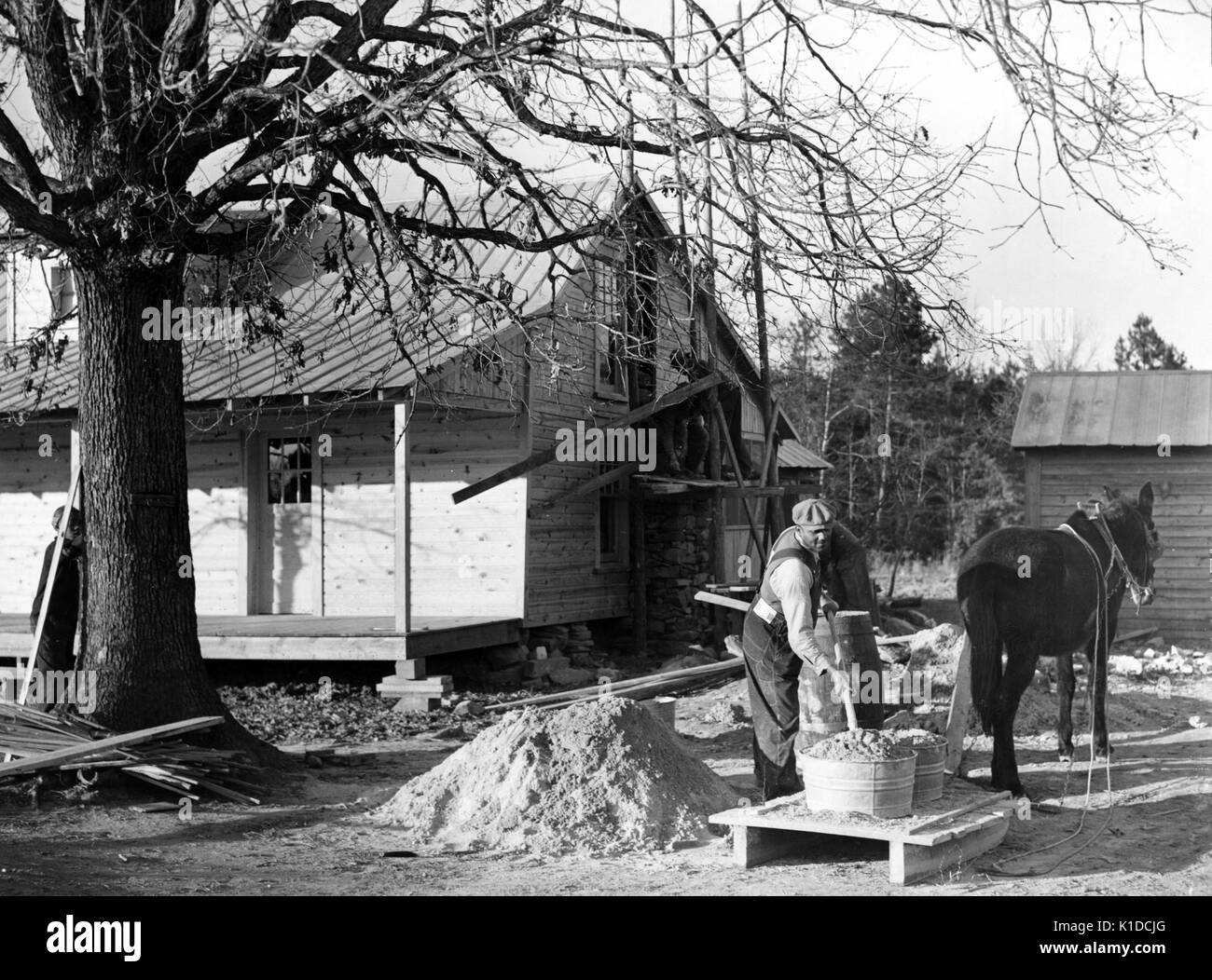 African-American Farm Security Administration rehabilitation client mixing cement to be used in construction of his new home, Raleigh, North Carolina, 1938. From the New York Public Library. Stock Photo