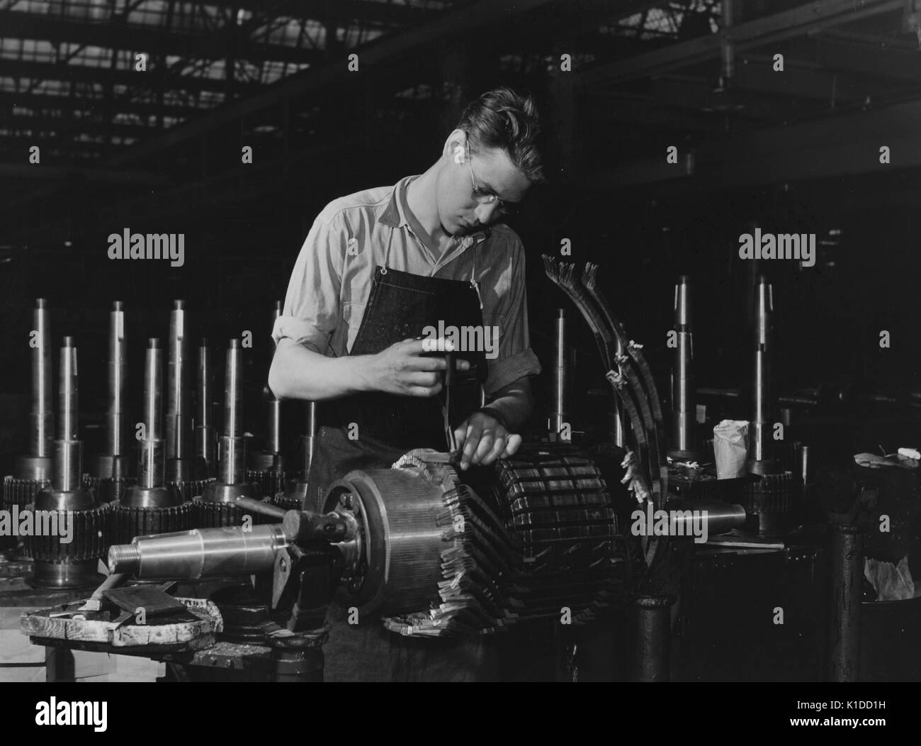 Jack Cutter, resident of FSA (Farm Security Administration) trailer camp, winding an armature at General Electric plant, Erie, Pennsylvania, 1941. From the New York Public Library. Stock Photo