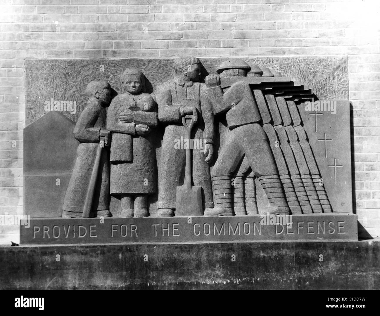 Works Projects Administration (WPA) bas-reliefs of soldiers with text reading Provide for the Common Defense, at Greenbelt school, Maryland, 1937. From the New York Public Library. Stock Photo