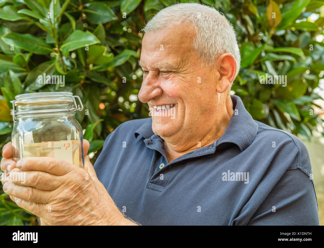Old man holding jar of money Stock Photo Alamy