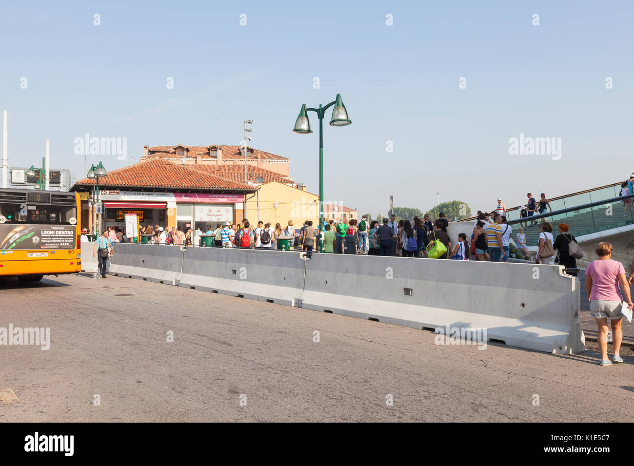 Venice, Italy. 26th Aug, 2017. Anti-terror preparations for the 2017 Venice Film Festival due to start on the 30 August. Overnight the first of the concrete barriers have been installed in the Piazzale Roma to protect pedestrians and the tram lines from vehicular terror attacks. close up on the section of barrier already in place in front of the public transport ticket office with tourist behind it. Credit: Mary Clarke/Alamy Live News Stock Photo