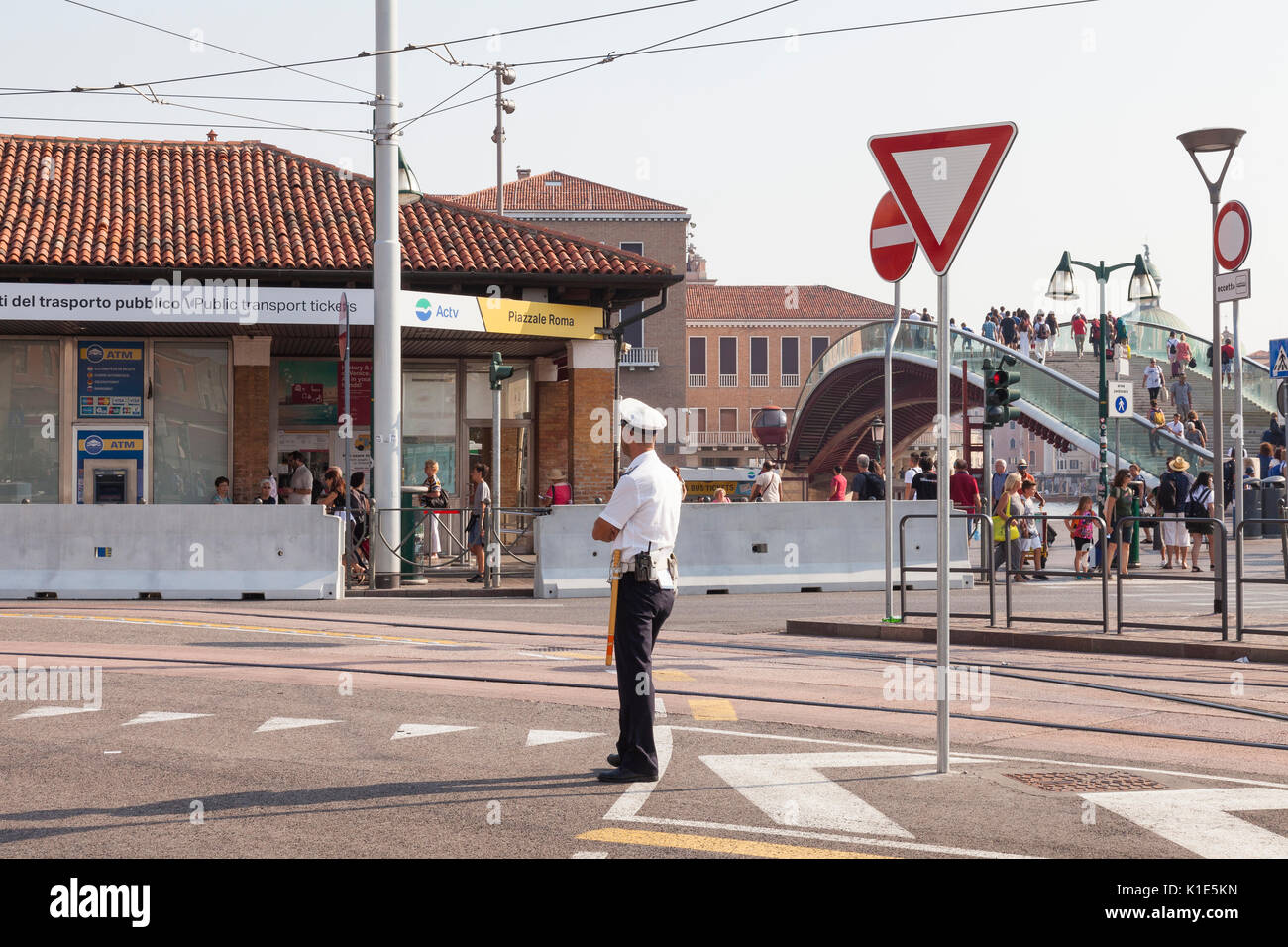 Venice, Italy. 26th Aug, 2017. Anti-terror preparations for the 2017 Venice Film Festival due to start on the 30 August. Overnight the first of the concrete barriers have been installed in the Piazzale Roma to protect pedestrians and the tram lines from vehicular terror attacks. Traffic or security officer on duty in front of barrier and ticket office. Credit: Mary Clarke/Alamy Live News Stock Photo