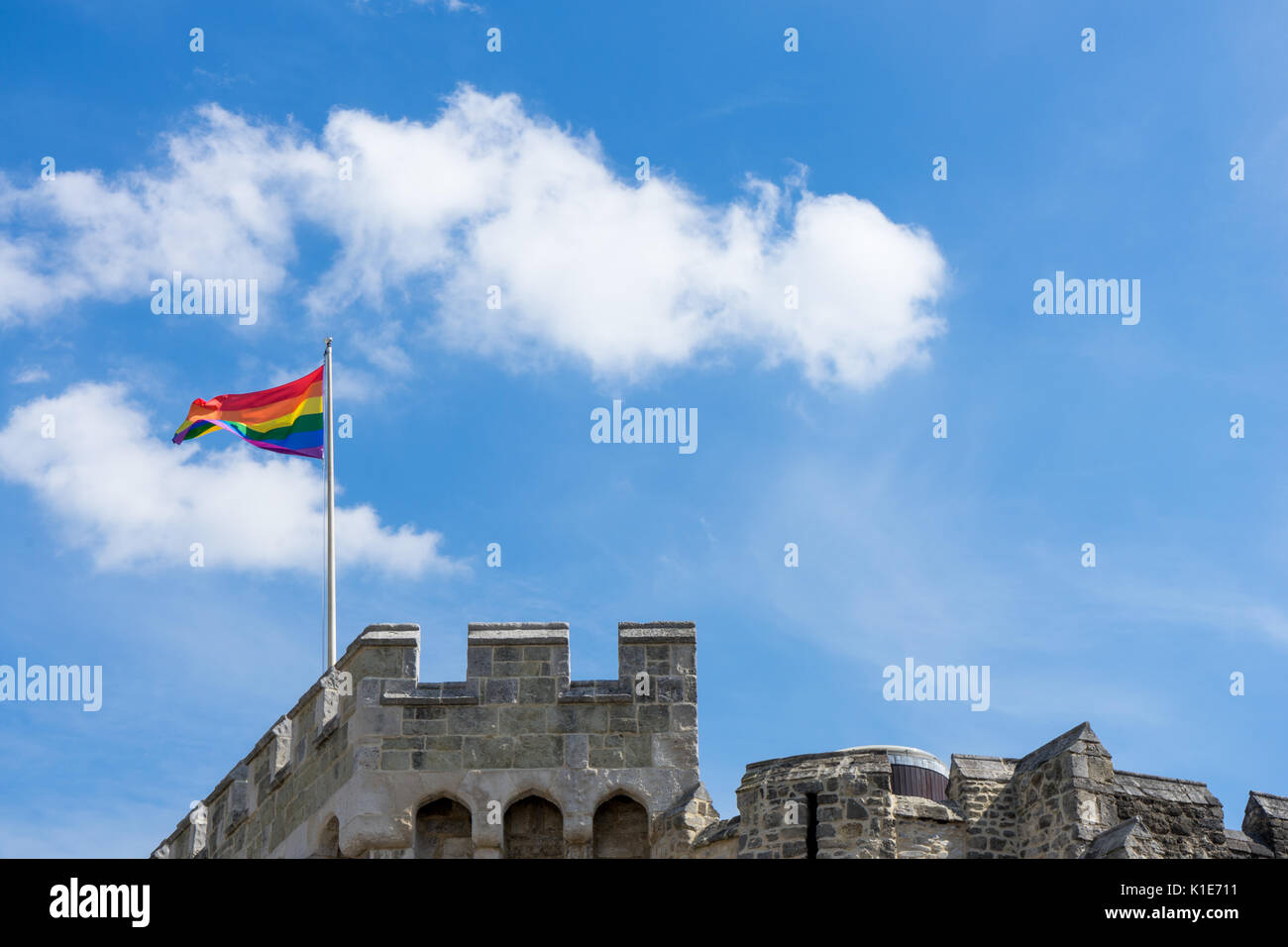 Southampton, UK. 26th of August 2017. The Rainbow flag against blue sky waving on top of the Bargate Centre in Southampton city centre as many people are taking to the streets to celebrate this year’s Annual Southampton Pride Festival 2017 during a spell of fine UK weather. Stock Photo