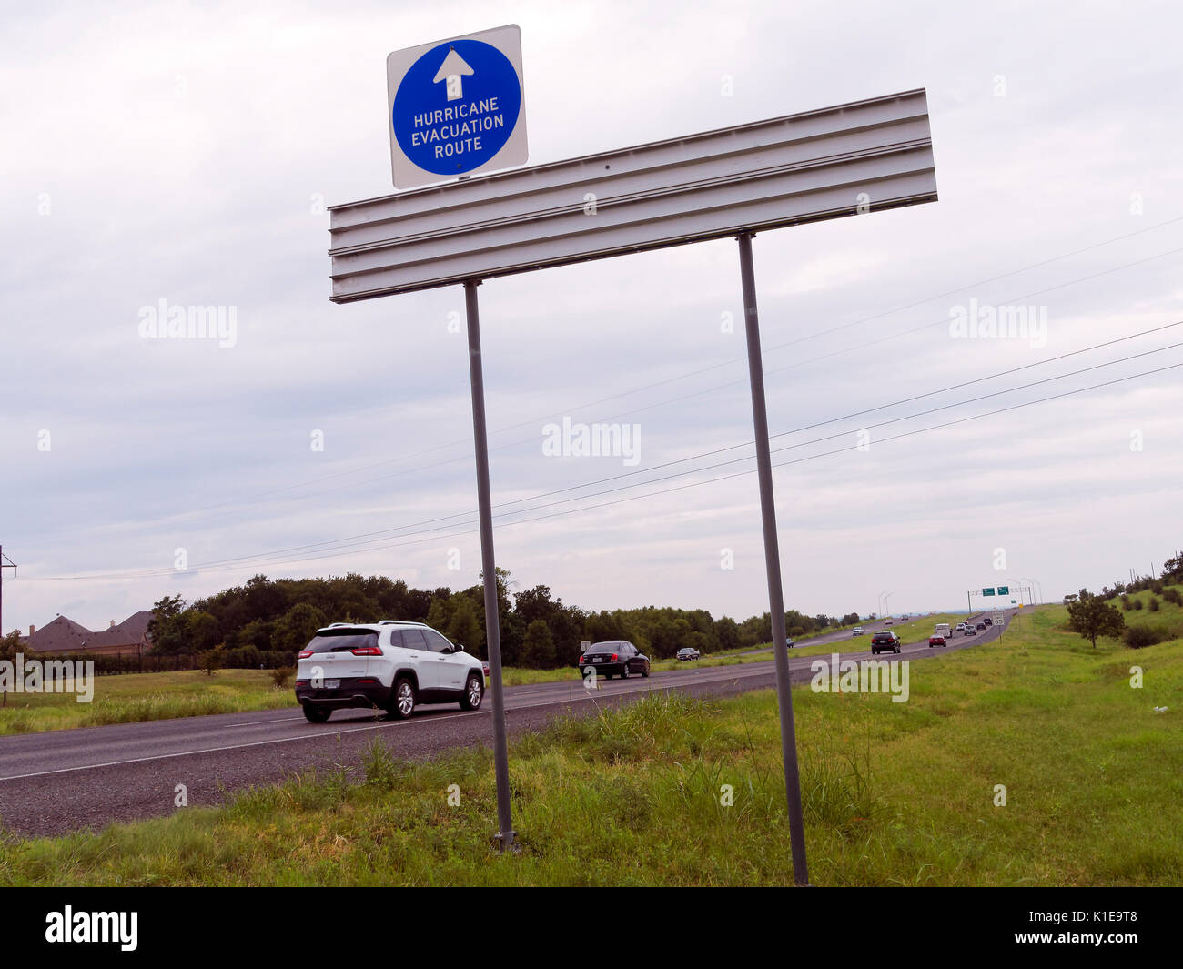 In Texas signs mark way for residents along the Gulf of Mexico coast to flee ahead of a sever storm. Just follow the signs as motel and hotel rooms fill and flooding force people out of their homes. No time to look on the map, just follow the signs Stock Photo