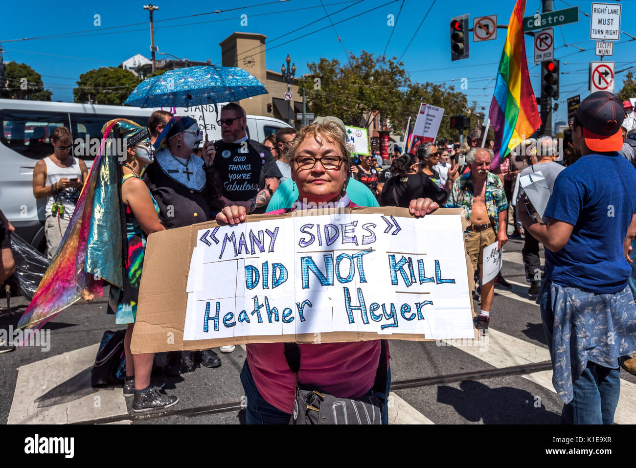 San Francisco, USA. 26th August, 2017, the No Hate rally and protest march in San Francisco. A woman protester holds a sign reading 'Many sides did NOT kill Heather Heyer.' The protesters gathered at Harvey Milk Plaza in San Francisco's Castro district for a rally before marching down Market Street to San Francisco City Hall. Originally planned as one of several counter protests to a previously planned demonstration by far right 'Patriot Prayer' group, which was cancelled the evening before. Credit: Shelly Rivoli/Alamy Live News Stock Photo