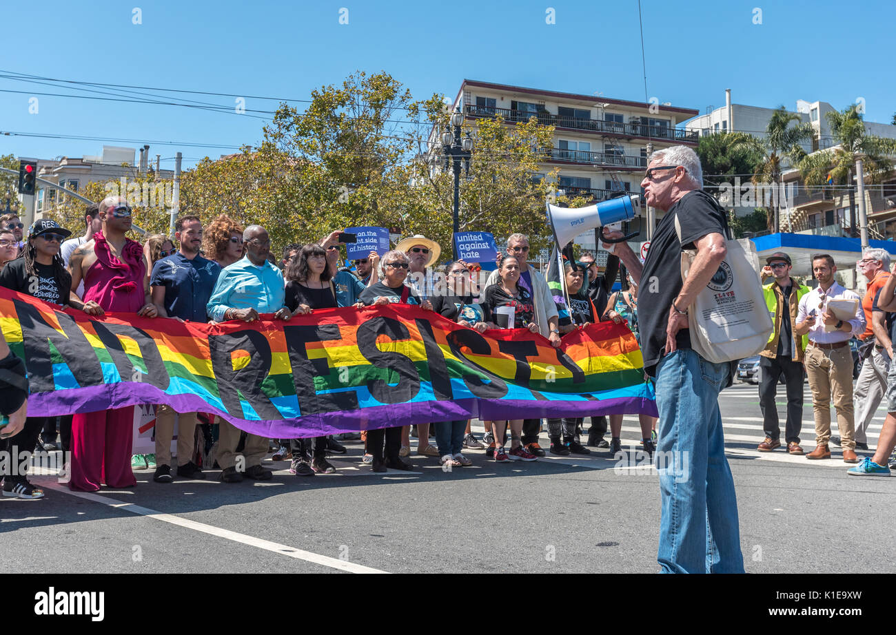 San Francisco, USA. 26th August, 2017, the No Hate rally and protest march in San Francisco. Longtime AIDS and LGBT activist Cleve Jones speaks to protesters gathered at Harvey Milk Plaza in San Francisco's Castro district before marching down Market Street to San Francisco City Hall. Originally planned as one of several counter protests to a previously planned demonstration by far right group 'Patriot Prayer,' protested alt right politics and recent statements by President Trump including Charlottesville, banning trans-gendered people from the military Credit: Shelly Rivoli/Alamy Live News Stock Photo