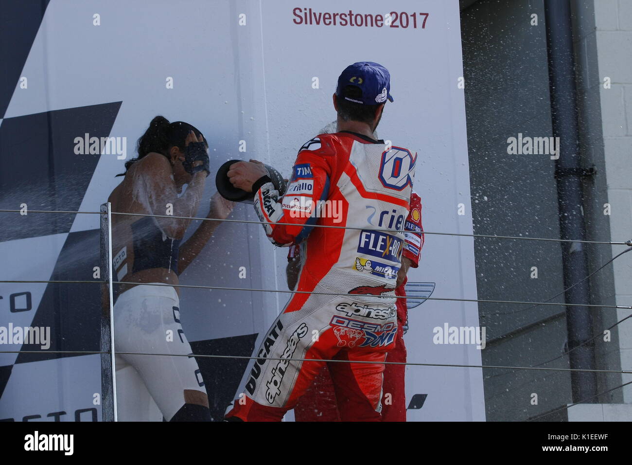 Silverstone, UK. 27th Aug, 2017. Now its the champagne girls! Winner  Dovizioso showers the OCTO promotion girl with bubbles after the OCTO  British MotoGP Credit: Motofoto/Alamy Live News Stock Photo - Alamy