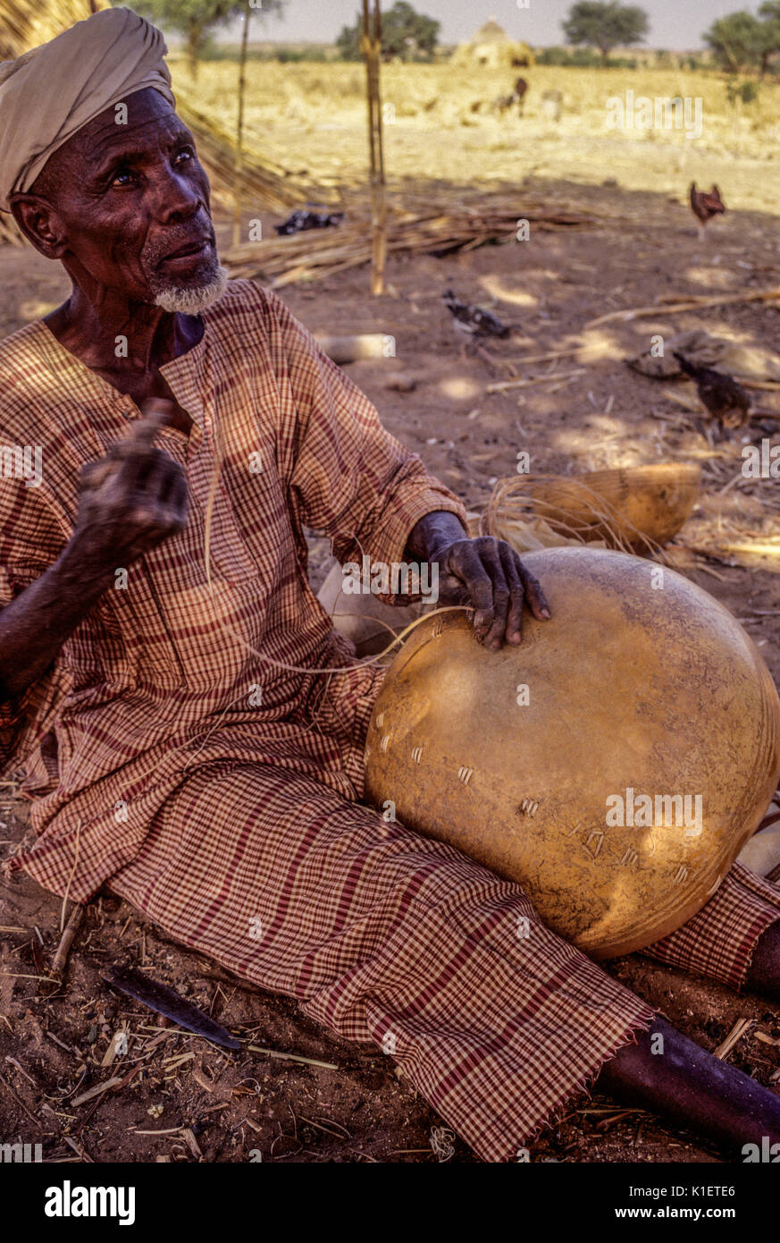 Niger, Delaquara,  West Africa.  Deaf Man Mending a Calabash. Stock Photo