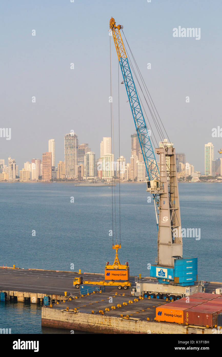 Cartagena, Colombia.  Unloading Containers in the Port.  Bocagrande Apartment Buildings in Background. Stock Photo