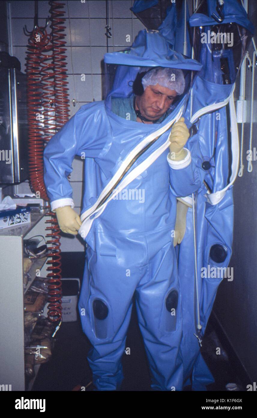 CDC scientist puts on a protective suit and face mask before entering Biosafety  Level 4 laboratory (BSL-4), Atlanta, GA, USA. LabScience, CDC scientist  puts on a protective suit and face mask before