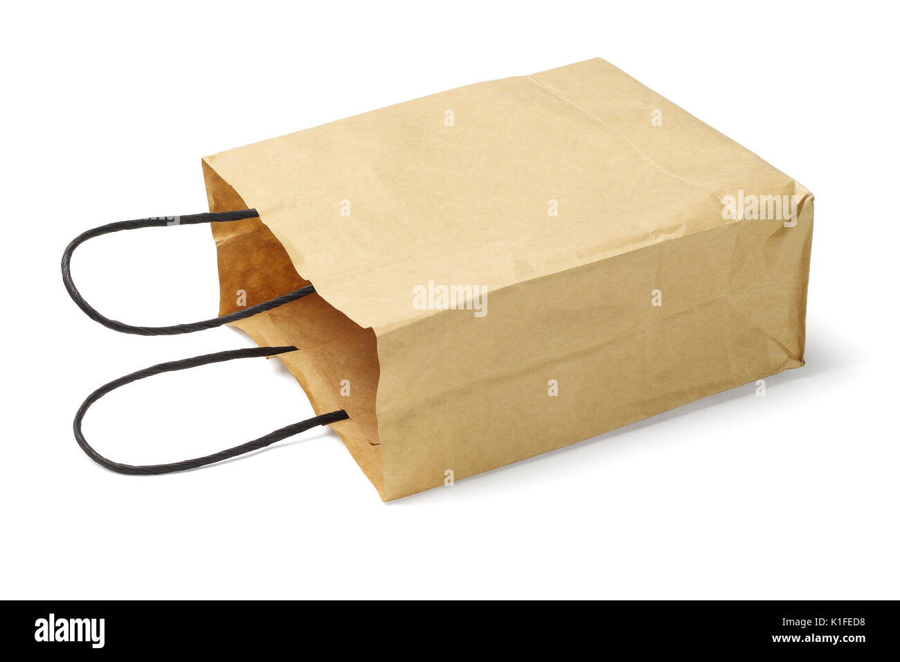 Recycled Paper Bag With Handle Lying on White Background Stock Photo