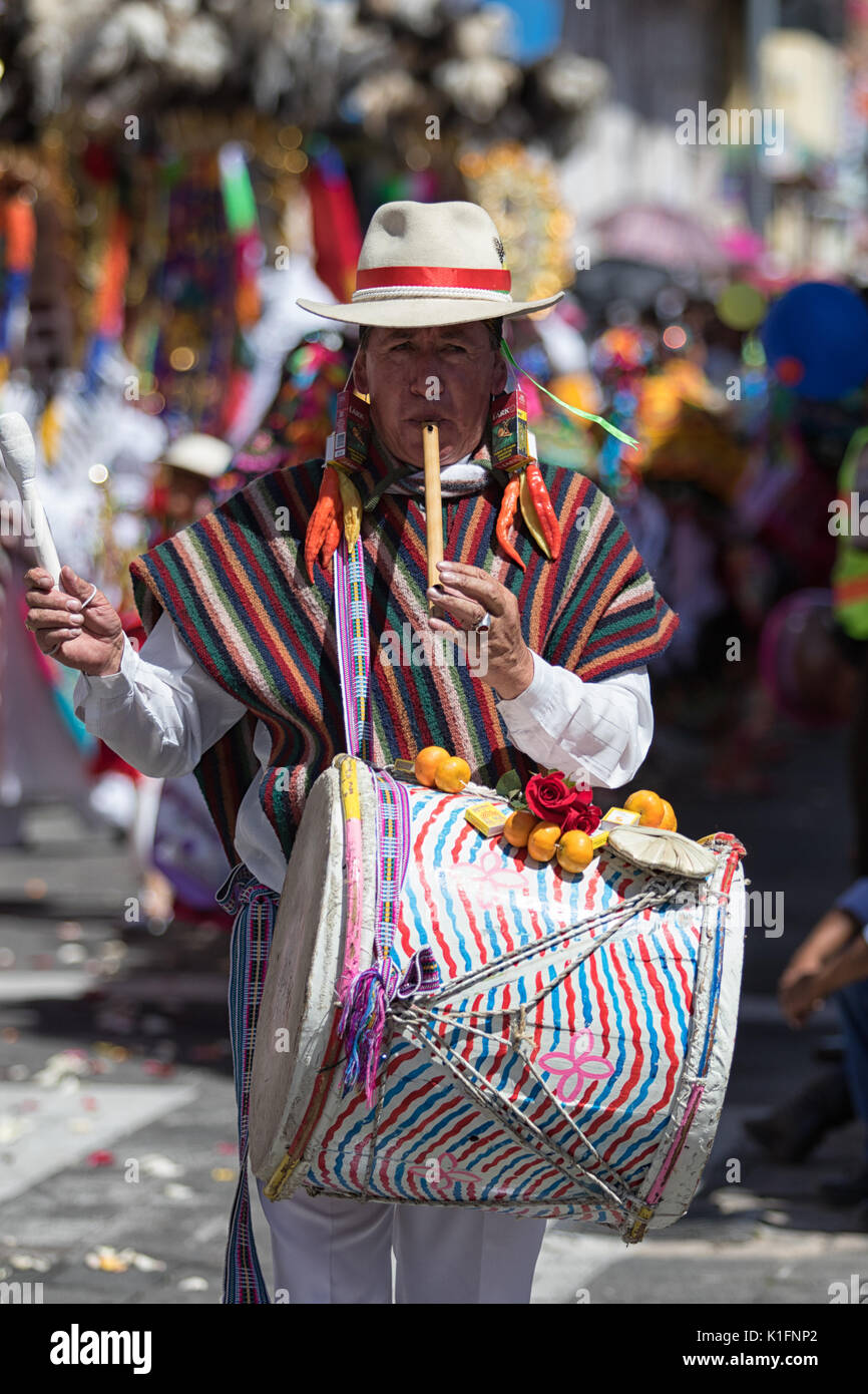June 17, 2017 Pujili, Ecuador: man playing on flute and drum simultaneosly walking the Corpus Christi parade Stock Photo