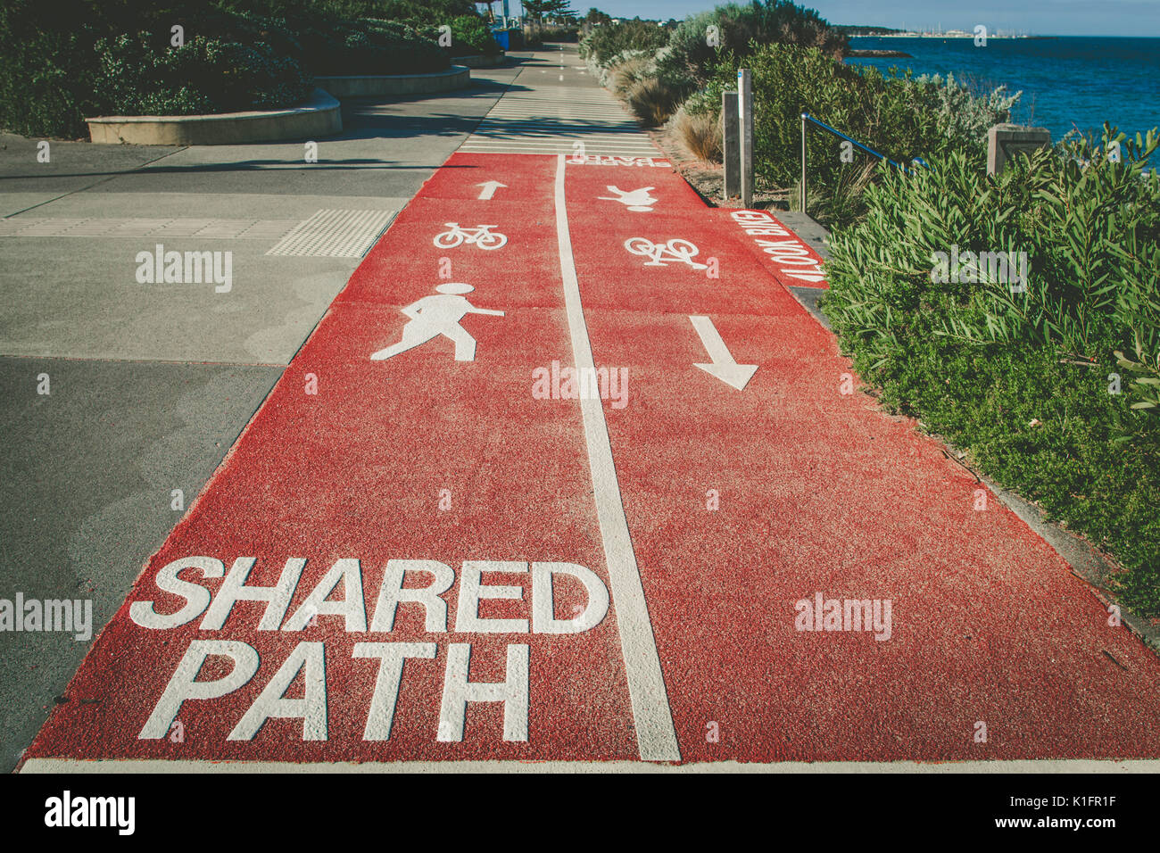 Shared Path sign written on footpath for cyclists and pedestrians with