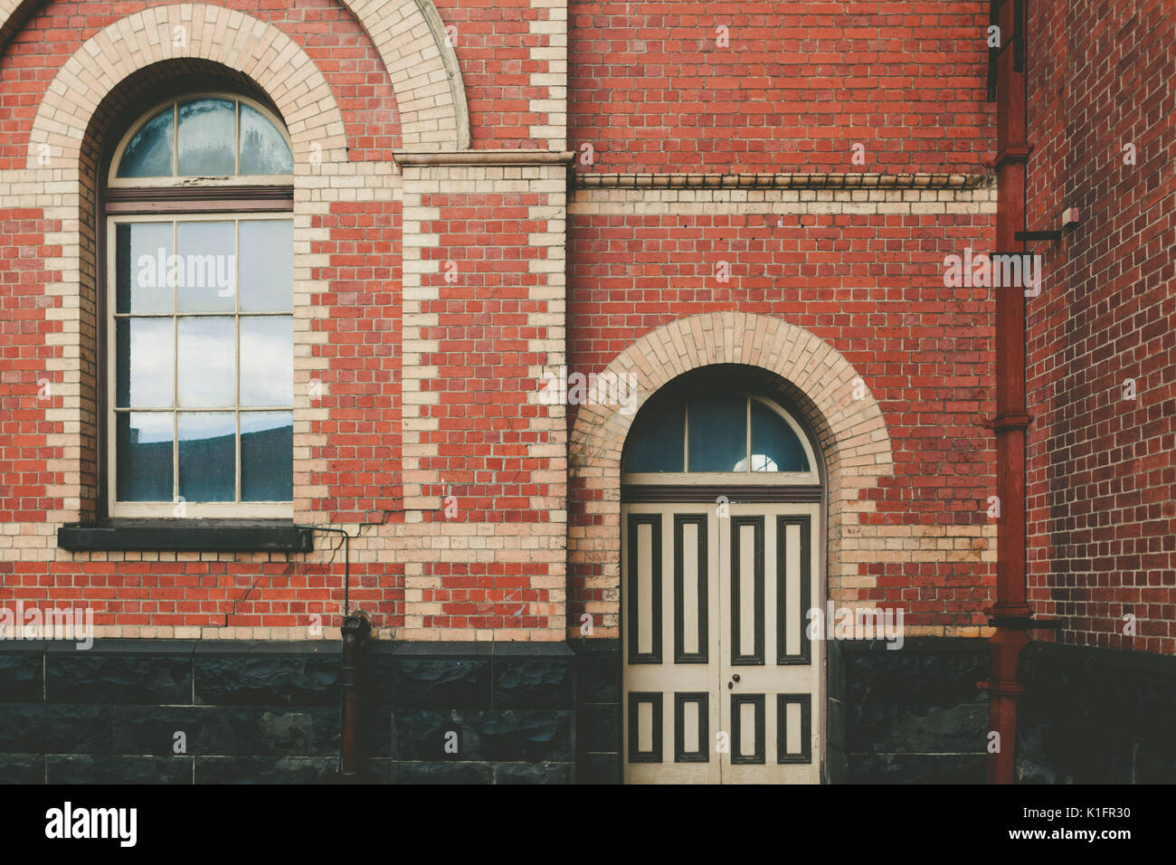 Vintage brick building wall with window and door Stock Photo - Alamy