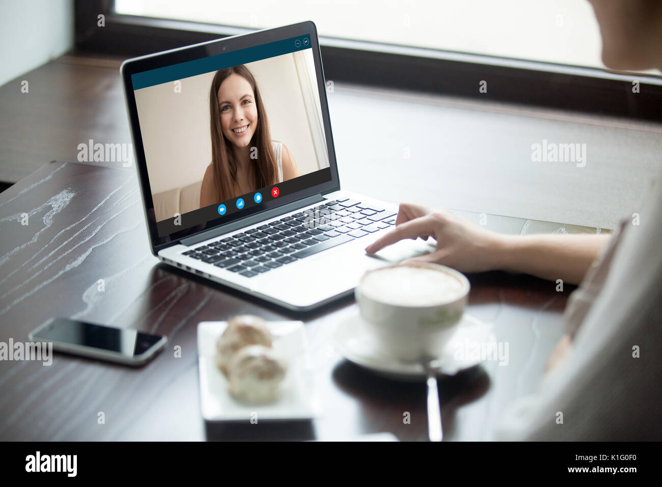 Woman making video call to girlfriend in cafe, close up Stock Photo