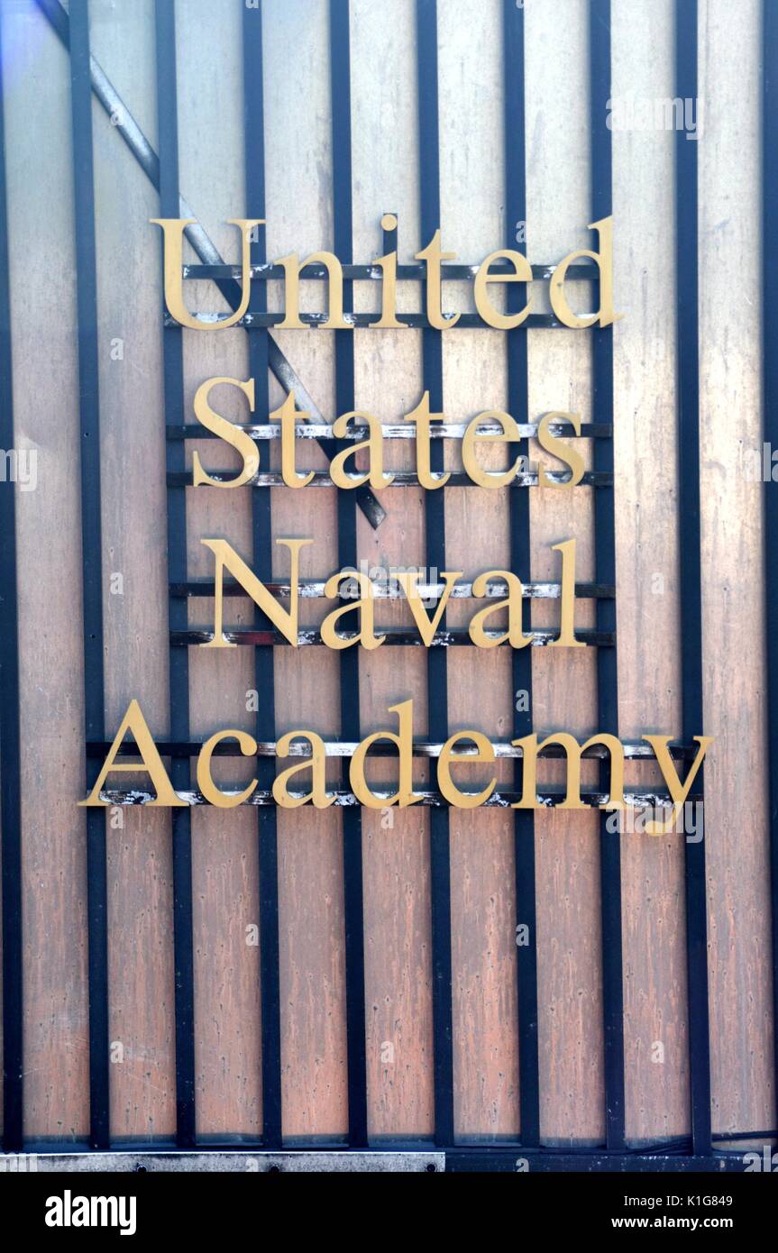 United States Naval Academy Sign with gold lettering on a shiny striped fence Stock Photo
