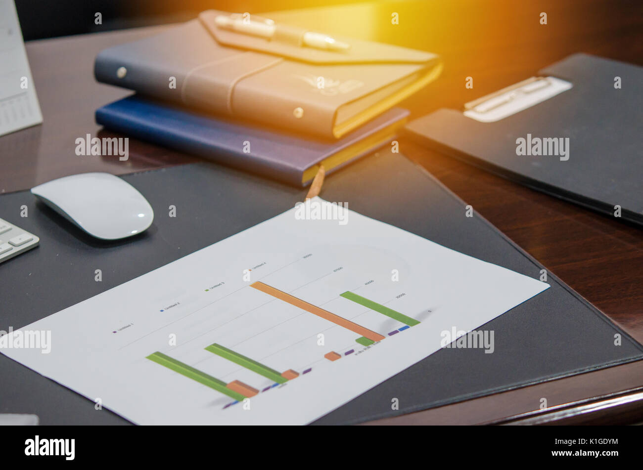 Documents, graphs and mouse Notebook on the desk Stock Photo