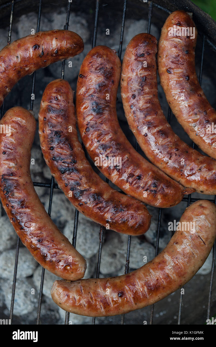 Traditional Polish sausages being prepared on a barbecue Stock Photo