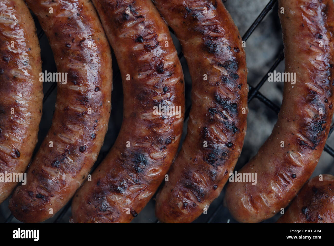Traditional Polish sausages being prepared on a barbecue Stock Photo