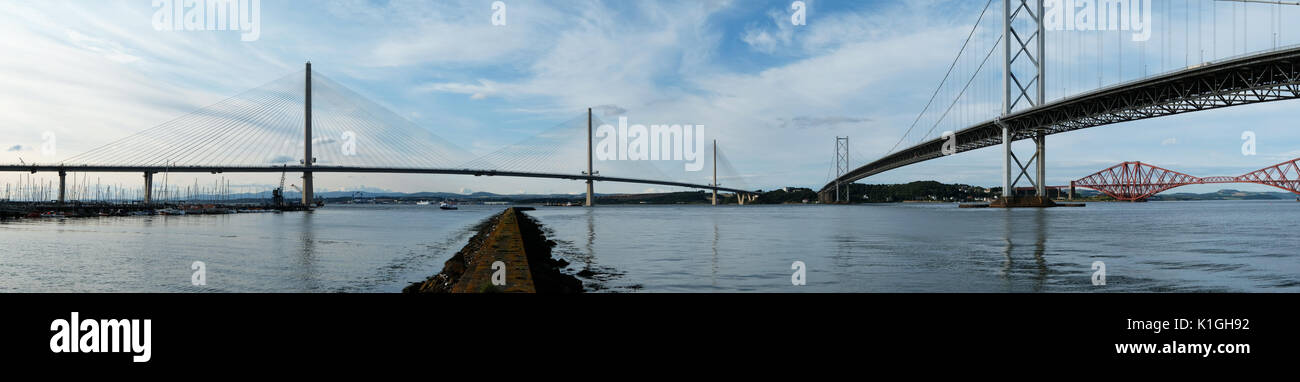 Panoramic view of the new Queensferry Crossing bridge, Forth Road bridge, and Forth Rail bridge from Port Edgar South Queensferry. Stock Photo