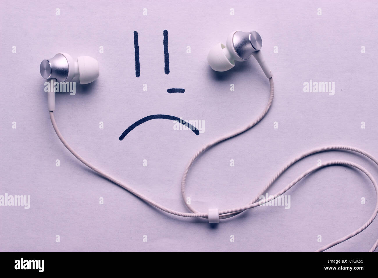 listen to sad music concept. headphones and sad smile Stock Photo Alamy