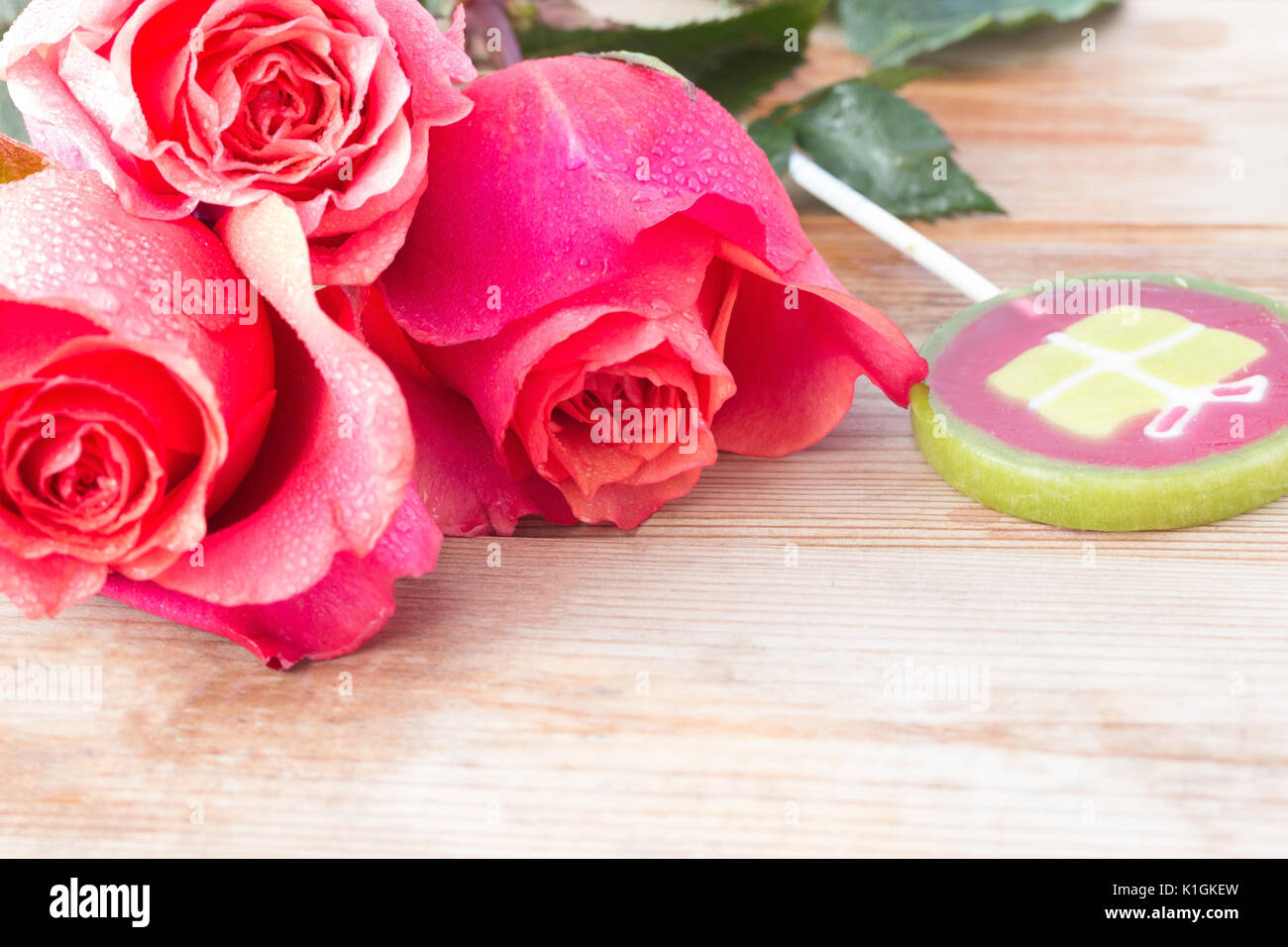 pink roses and sweets on table. copy space Stock Photo