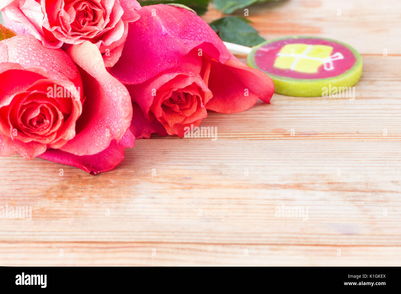pink roses and sweets on table. copy space Stock Photo