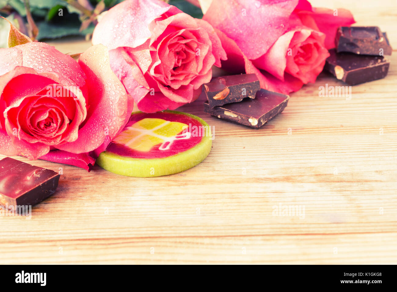 pink roses and sweets on table. copy space Stock Photo
