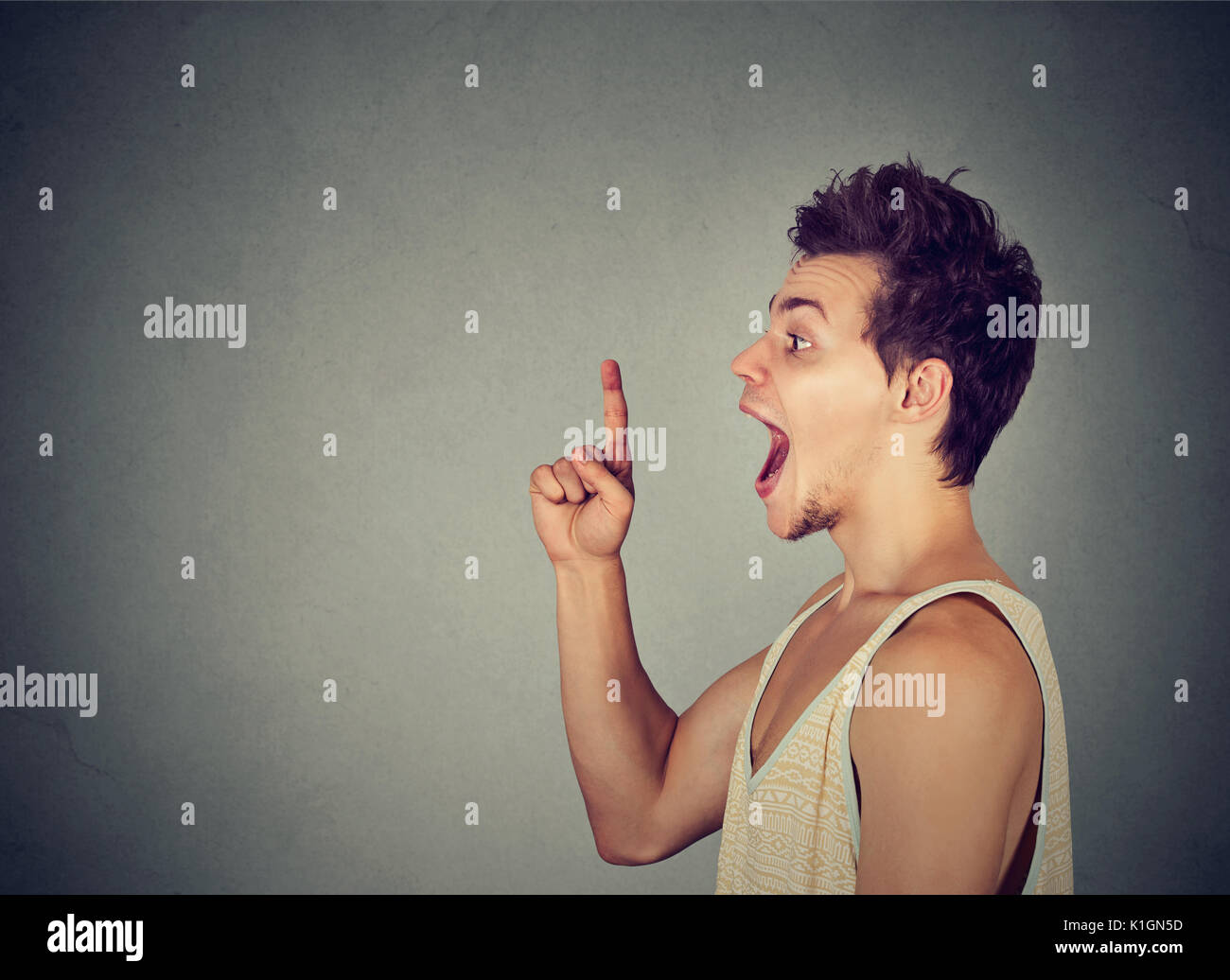 Excited man has a new idea pointing finger up Stock Photo