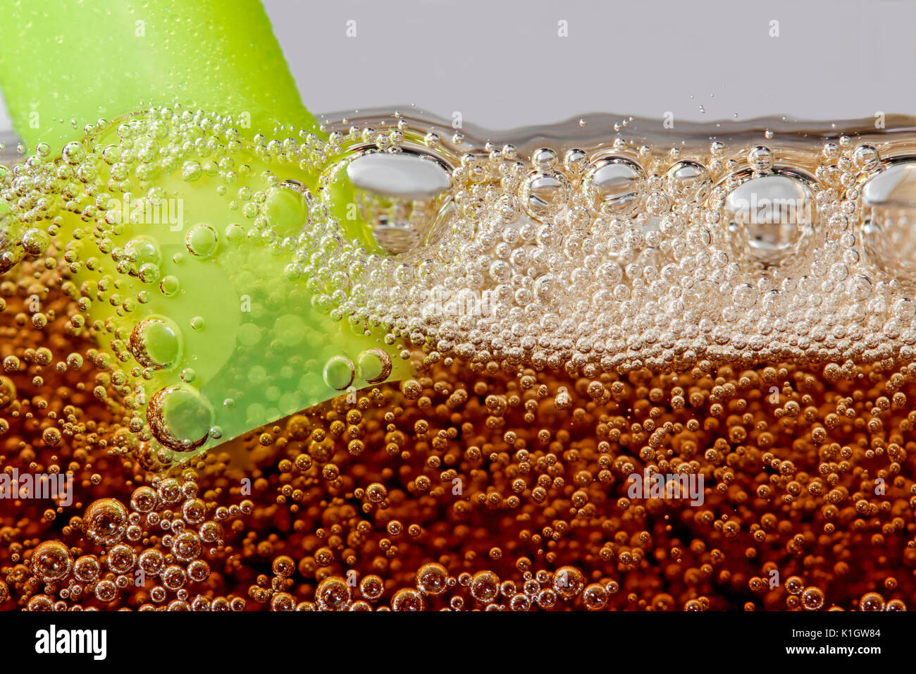 Coca-cola bubbles with a straw Stock Photo - Alamy