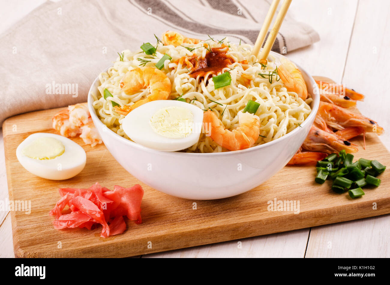 Chinese noodles with shrimp, spring onion and sliced eggs in soy sauce