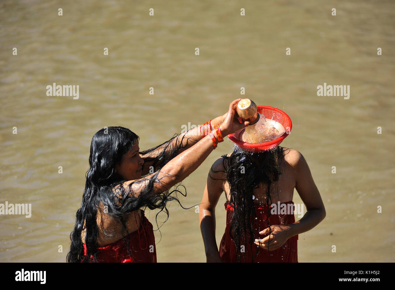 Nepalese Hindu Woman Takes A Ritual Bath At The Bagmati River Of Pashupatinath Temple During