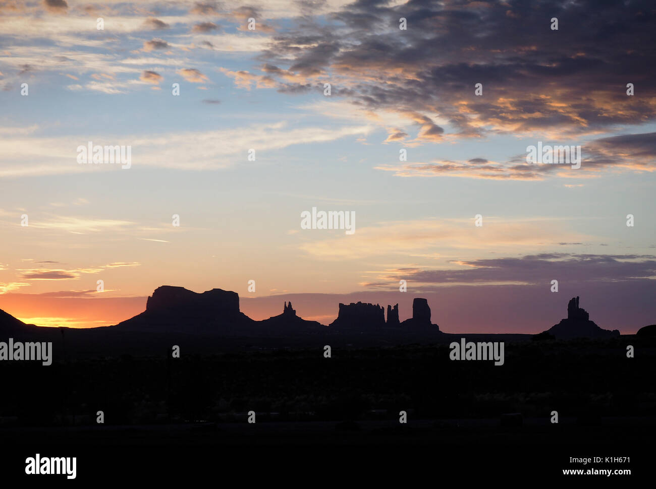The sun is raising behind the rock formations of Monument Valley, USA ...