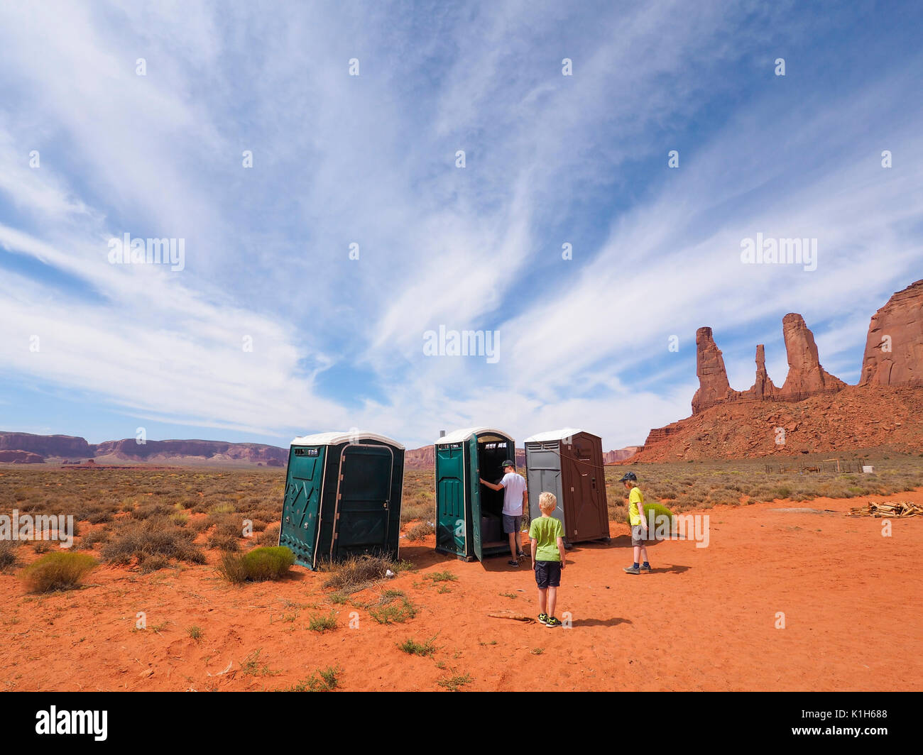 Monument Valley, USA - 25 July 2016: Tourists are inspecting portable portapotty toilets at a car park at Monument Valley Navajo Tribal Park. Stock Photo