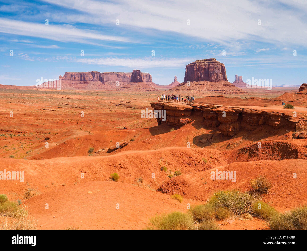 A group of tourists is watching Monument Valley from a scenic viewpoint. Stock Photo