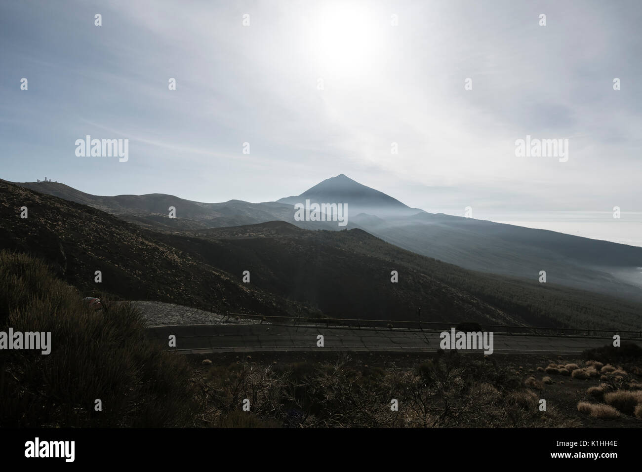 The Pico del Teide behind fog against the light in Tenerife, Spain seen from an observation point in La Tarta. Stock Photo