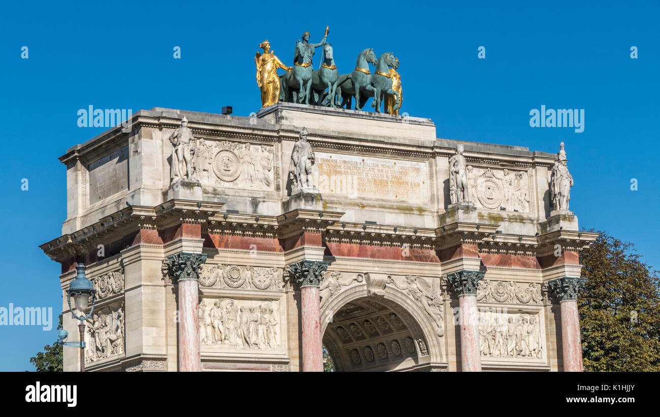Sunlit top of The Arc de Triomphe du Carrousel ( triumphal arch ), with ...