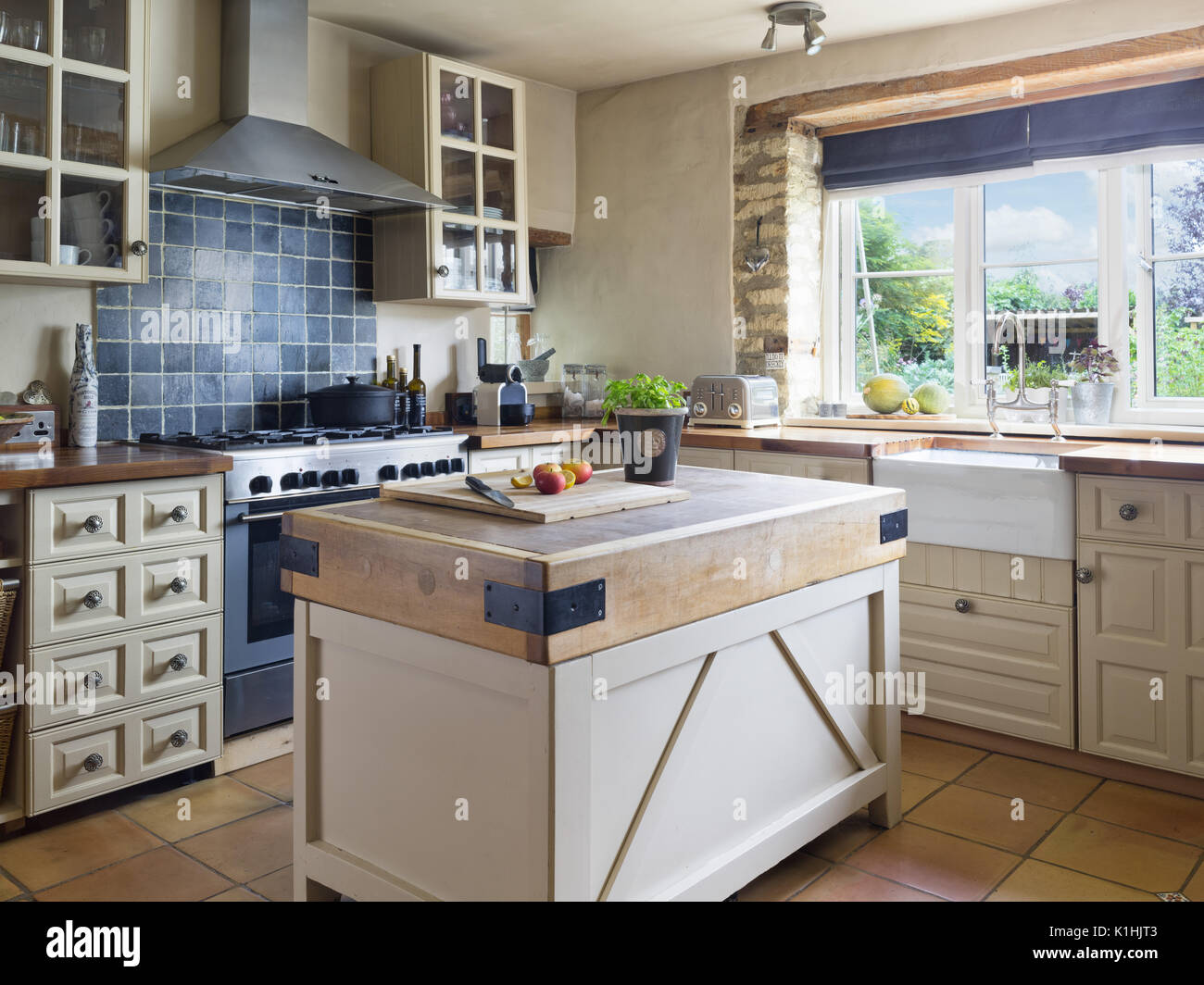 A contemporary country kitchen with island preparation space Stock Photo