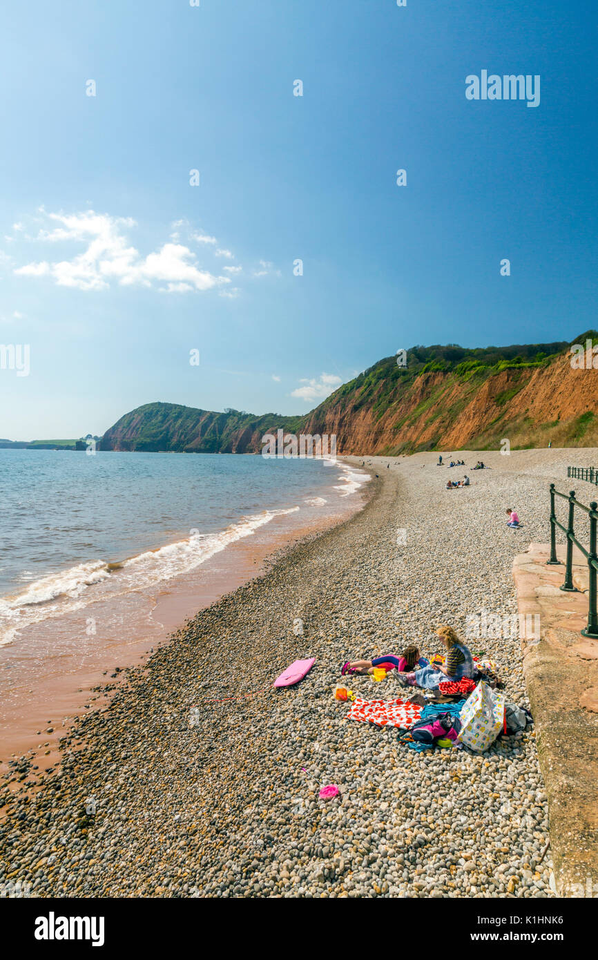 Holidaymakers on the beach at Sidmouth, which has both sand and pebbles on the Jurassic Coast, Devon, England, UK Stock Photo