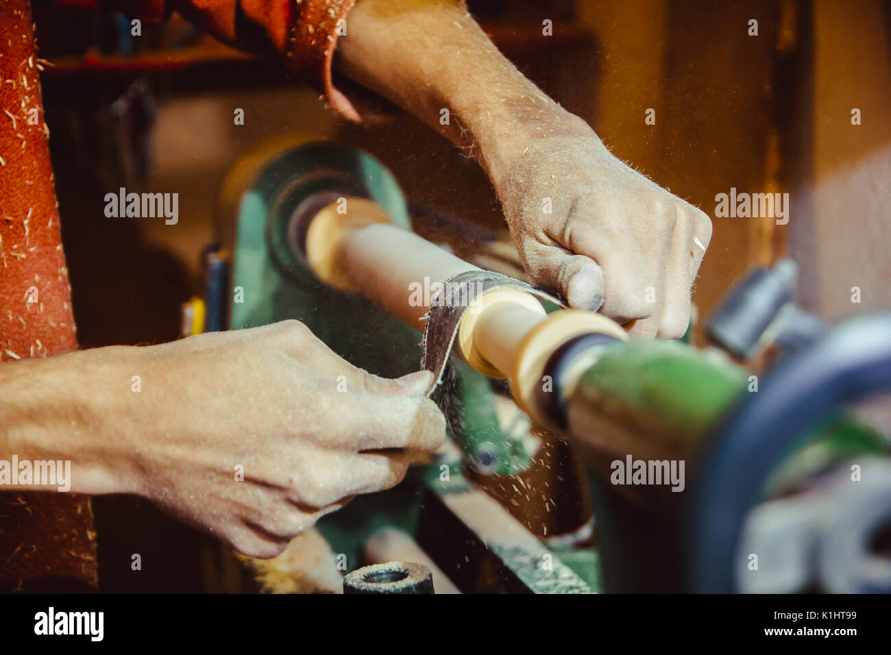 Wood turners using sandpaper polished wood on a lathe Stock Photo Alamy